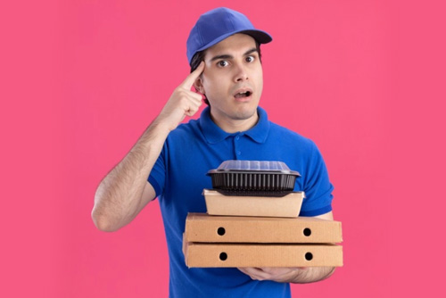delivery guy holding pizza and other snacks with food packaging